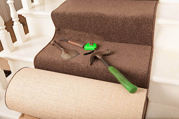 Tools and roll of stair carpet being fitted.